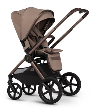 Venicci upline 3 travel system stroller in sand with beige and bronze fabric, black wheels, and mesh storage basket