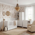 Bebe & Beyond Wanderer White 3 Piece Nursery Furniture Set with convertible cot bed, under-bed storage drawer, wide changing unit and wardrobe.