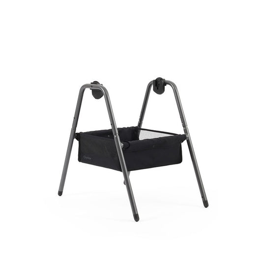 Black fabric bassinet with sleek modern metal frame babyStyle oyster carrycot stand shown from the back side