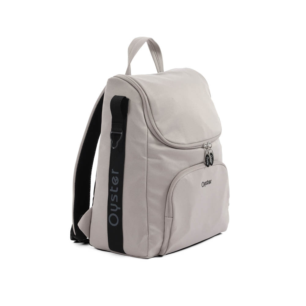 Light gray oyster backpack with black shoulder strap and logo accents from oyster 4 stone luxury travel system