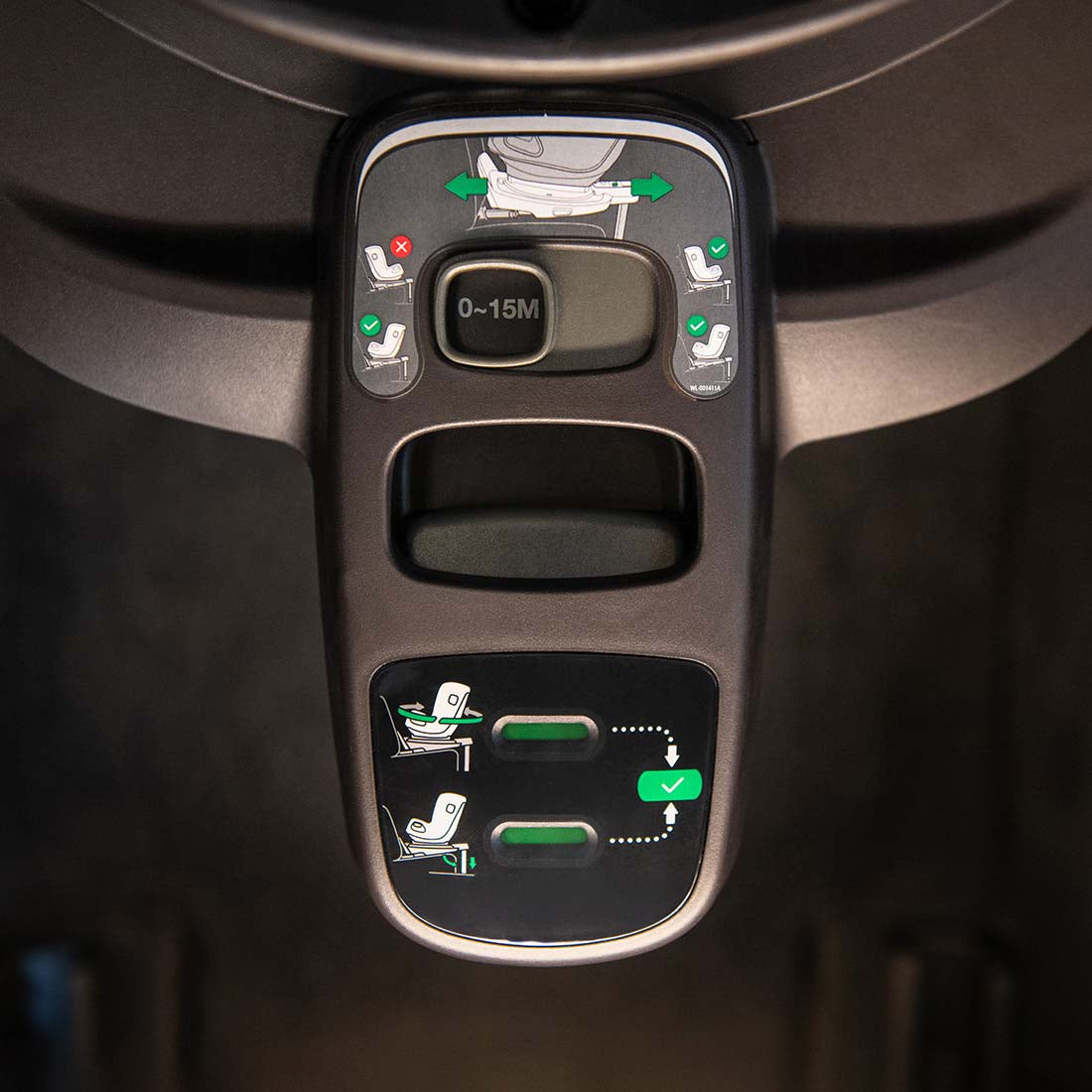 Black plastic control panel with green and white diagrams on Nuna BASE curv ISOFIX 360° rotating slide car seat base back side