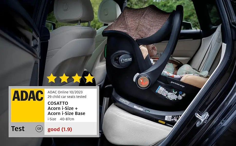 Black cosatto acorn i-size car seat with a brown herringbone-patterned canopy.