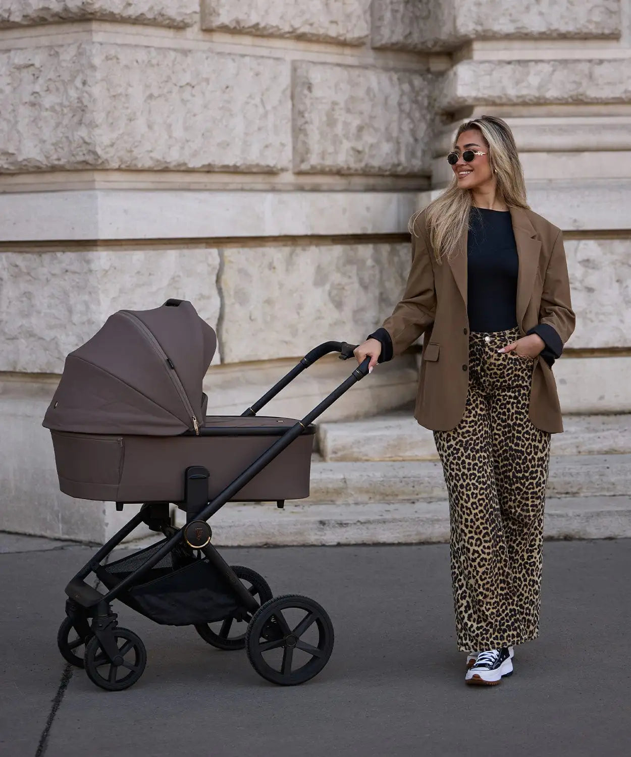 Brown stroller with black frame and wheels.