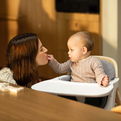 Nuna BRYN highchair white with gray cushioned seat and tray designed for comfortable infant seating and feeding