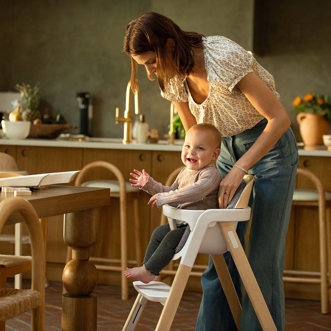 White and light wood Nuna BRYN highchair with modern minimalist design for comfortable baby seating