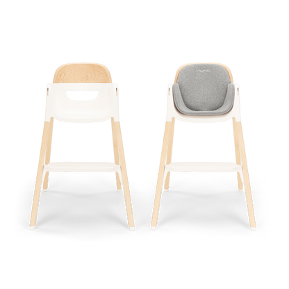 Nuna BRYN highchair with light wood legs white frame and beige upholstered seat in modern heritage design