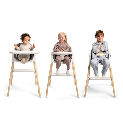 Nuna BRYN highchair in white and light wood with adjustable seating for toddlers in a modern design