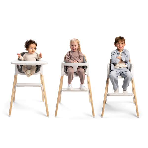 Nuna BRYN highchair in white and light wood with adjustable seating for toddlers in a modern design