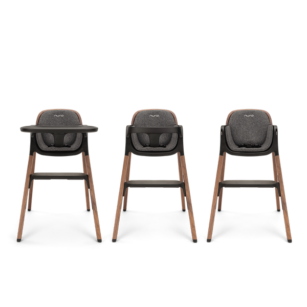 Three nuna bryn highchairs with dark gray upholstered seats and wooden legs for comfortable baby seating