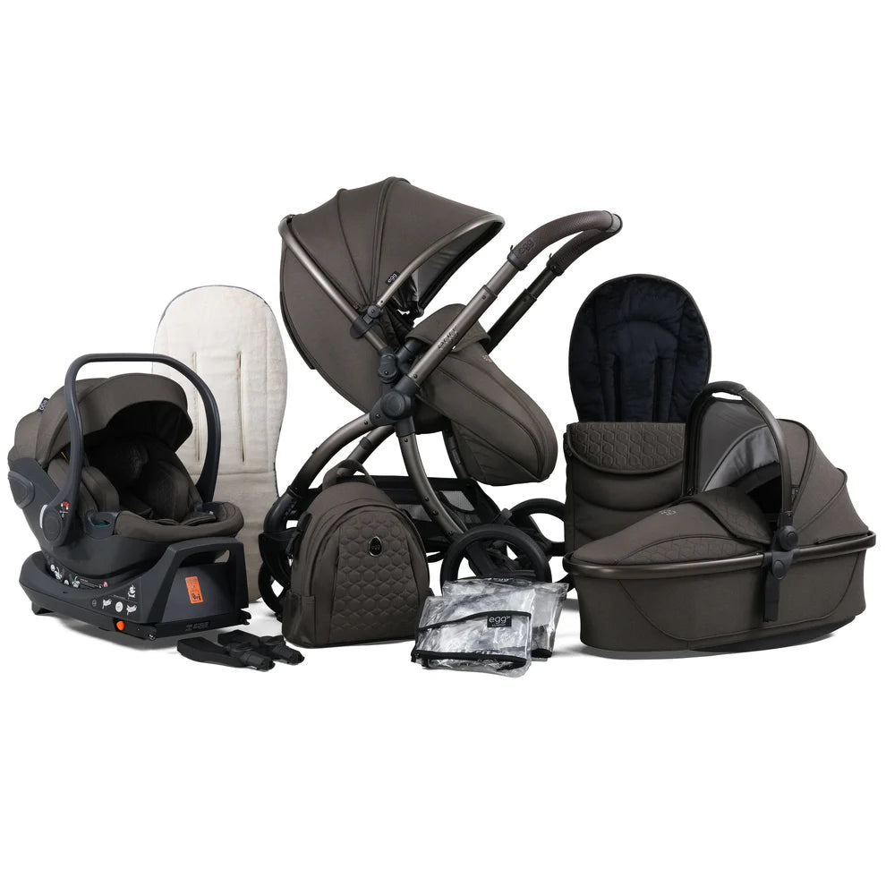 Dark olive green pram with a matching carrycot, bassinet, and car seat set.