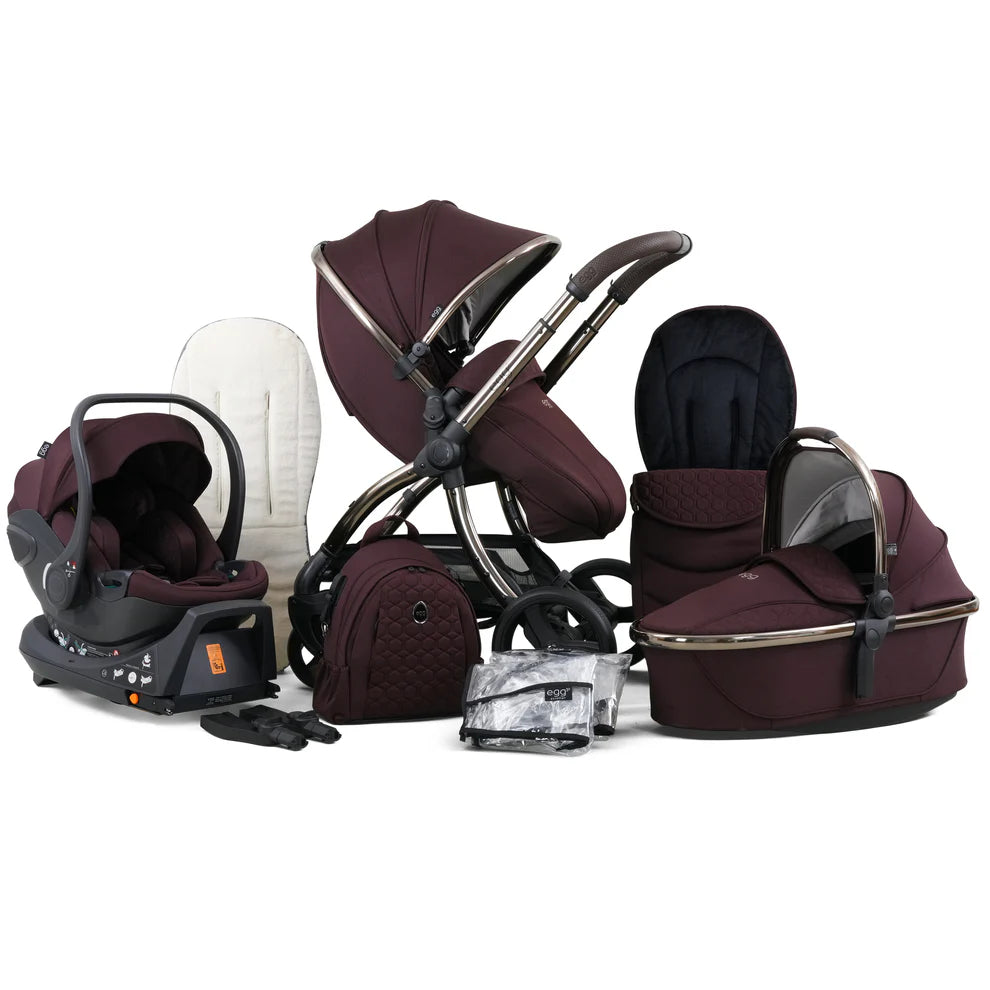 Maroon and black baby stroller set with quilted fabric, metallic frame accents, and matching carrycot.