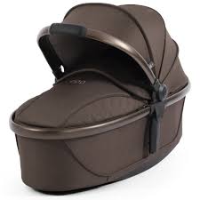 Brown oval baby bassinet with quilted fabric exterior and metallic trim in the egg3 chocolate velvet 360 bundle