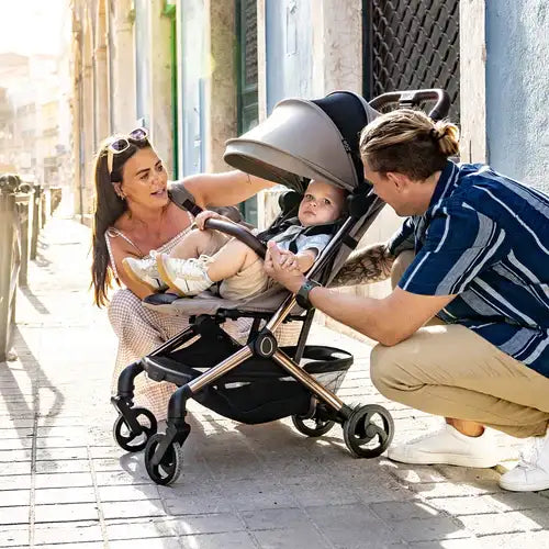 Modern gray and black stroller with a sleek, foldable design.