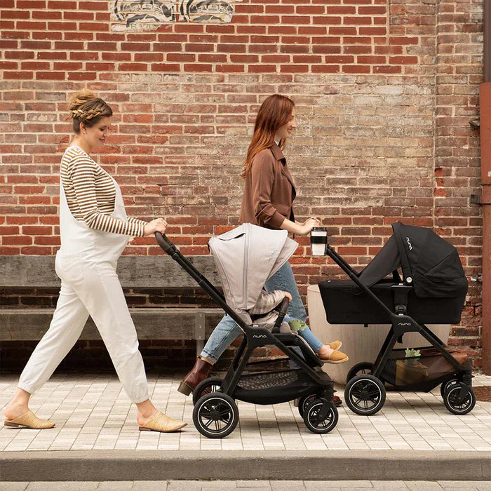 Black and gray nuvo stroller with a sleek, modern design and four wheels.