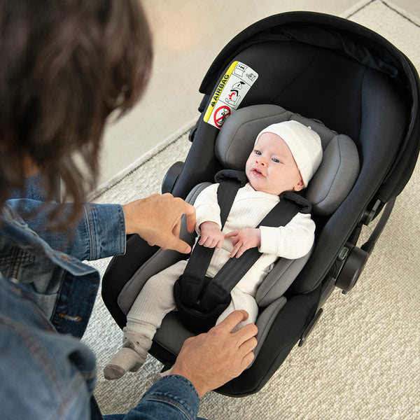 Black and gray Nuna ARRA Flex infant car seat with adjustable harness straps for flat recline i-Size baby safety