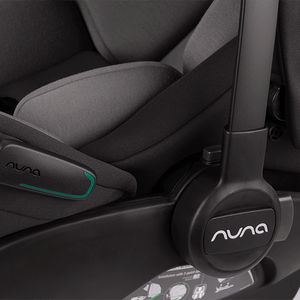 Black nuna arra flex infant car seat with gray fabric upholstery and teal accent line for flat recline i-size use