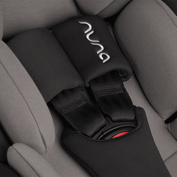Black nuna seat belt cover with silver embroidered logo and red buckle accent for nuna arra flex car seat