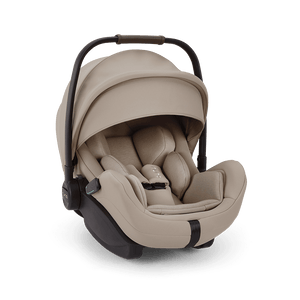 Beige nuna arra flex infant car seat with black frame and adjustable handle for flat recline i-size baby comfort