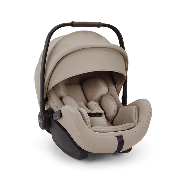 Beige nuna arra flex infant car seat with black frame and adjustable handle for flat recline i-size baby comfort