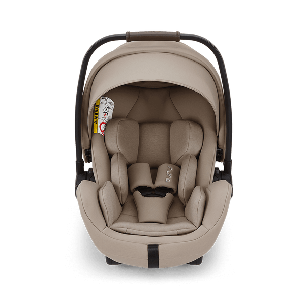 Beige nuna arra flex car seat with sleek modern design padded fabric upholstery and flat recline i-size baby seat