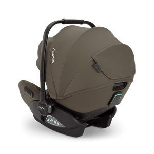 Nuna arra flex car seat pistachio in muted olive green fabric with black accents and subtle teal lighting details