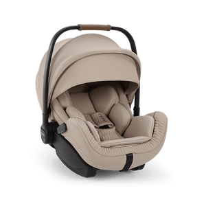 Beige nuna arra flex baby car seat with quilted fabric interior and black metal frame for flat recline i-size use