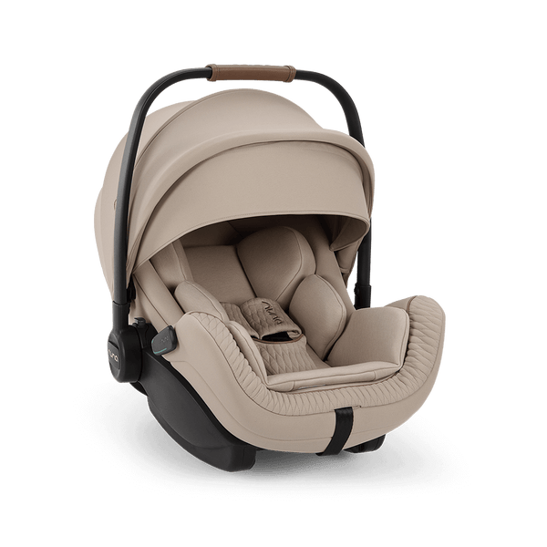 Beige nuna arra flex baby car seat with quilted fabric interior and black metal frame for flat recline i-size use