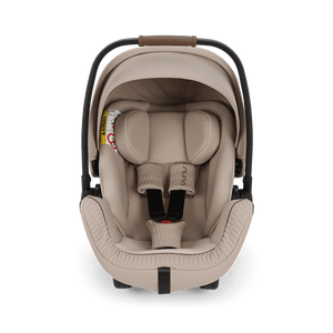 Beige Nuna ARRA Flex infant car seat with black frame and adjustable harness straps for i-Size babies 0 to 13 kg