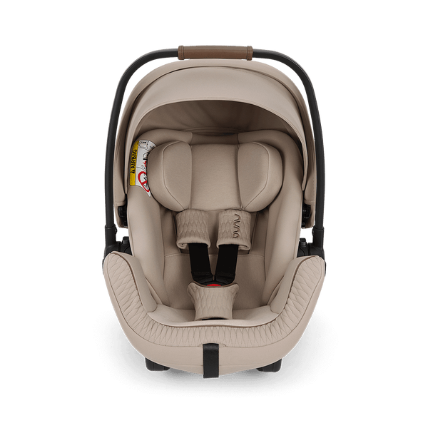 Beige Nuna ARRA Flex infant car seat with black frame and adjustable harness straps for i-Size babies 0 to 13 kg