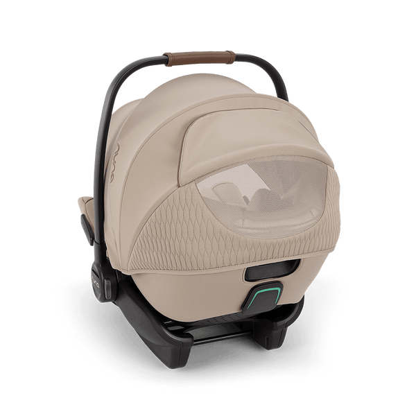 Beige nuna arra flex car seat with textured fabric cover black frame and handle grip for 0-13kg infants
