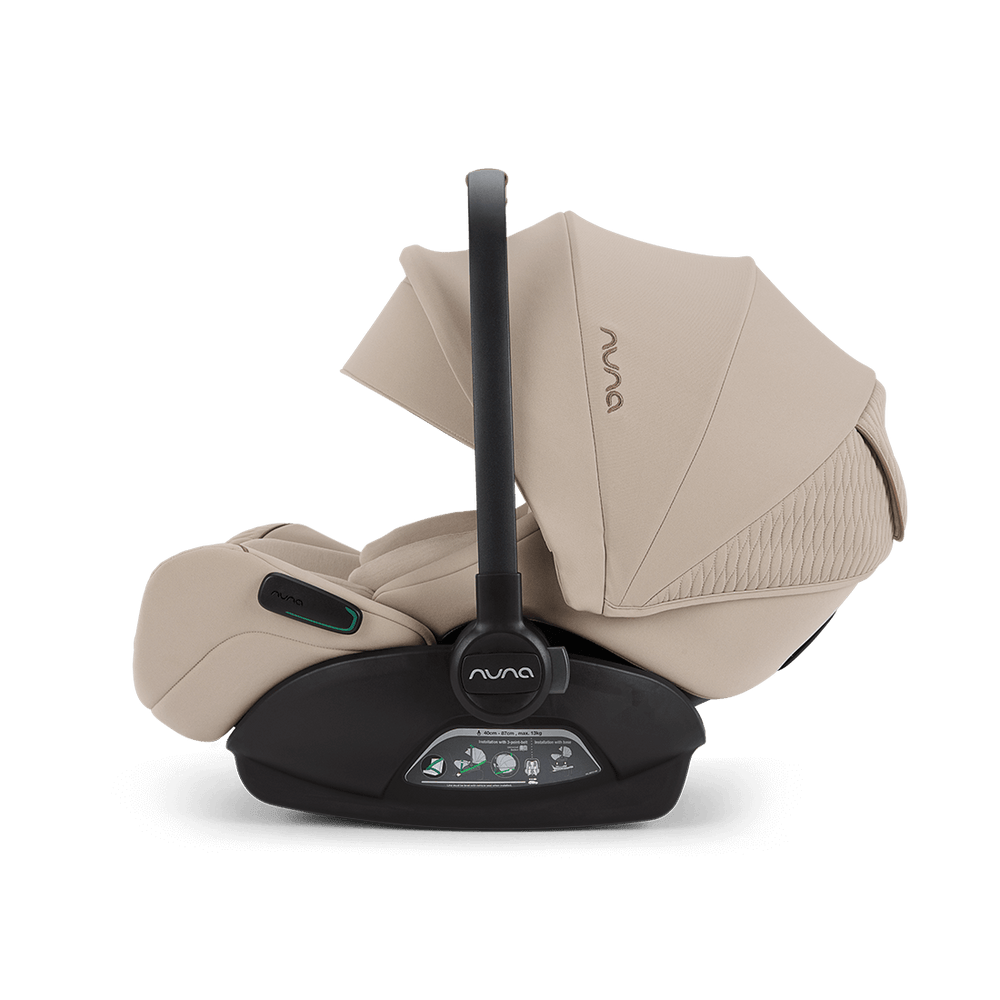 Beige nuna arra flex car seat with black handle and base designed for flat recline i-size baby safety up to 13kg