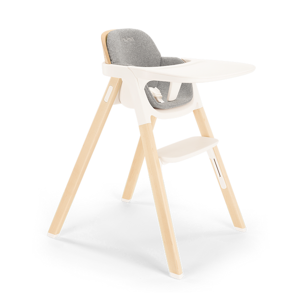 Modern Nuna BRYN highchair with light wood legs white plastic frame and gray upholstered seat for babies and toddlers