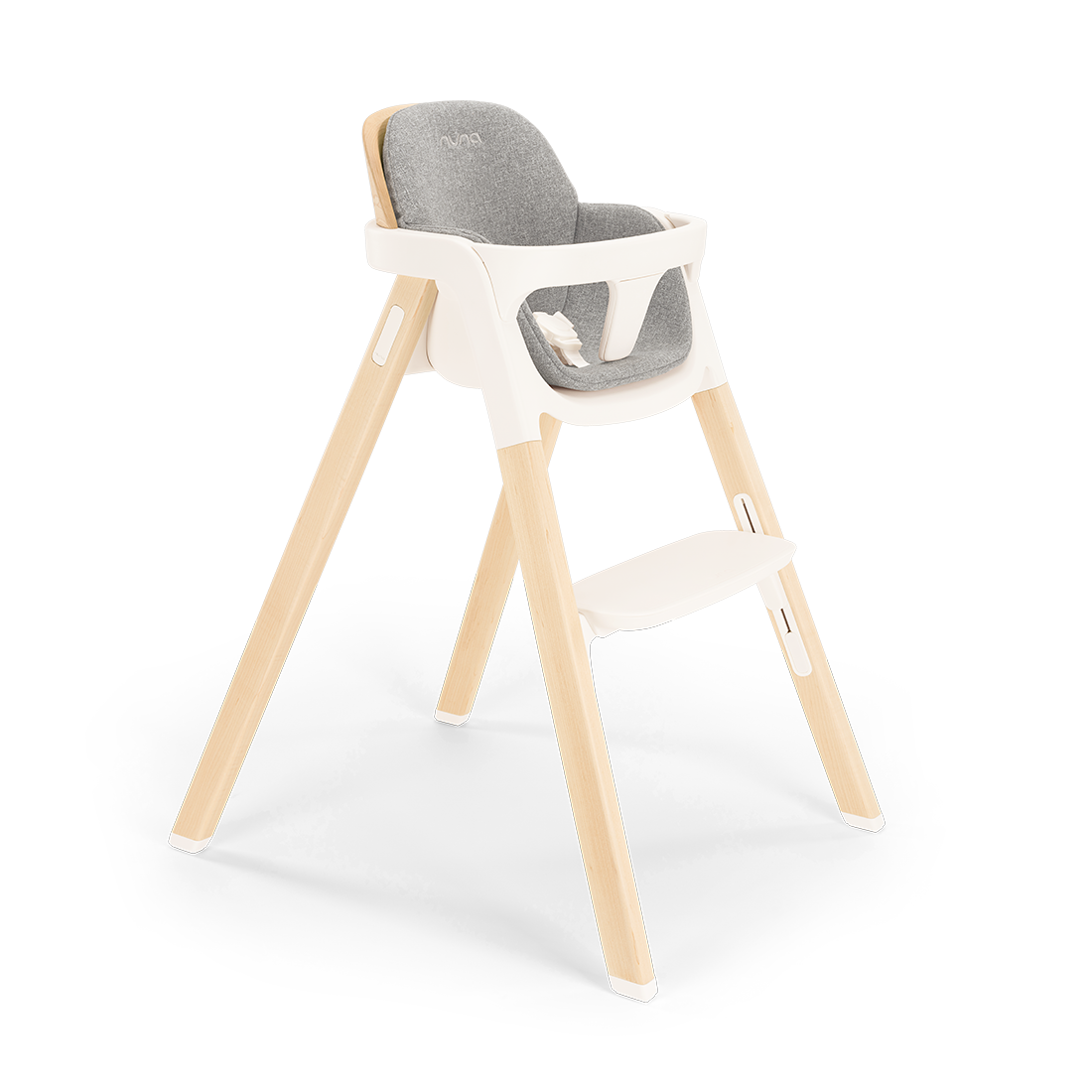 Nuna BRYN highchair with light wood legs white plastic frame and gray upholstered seat for modern dining