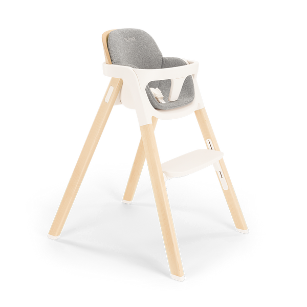Nuna BRYN highchair with light wood legs white plastic frame and gray upholstered seat for modern dining