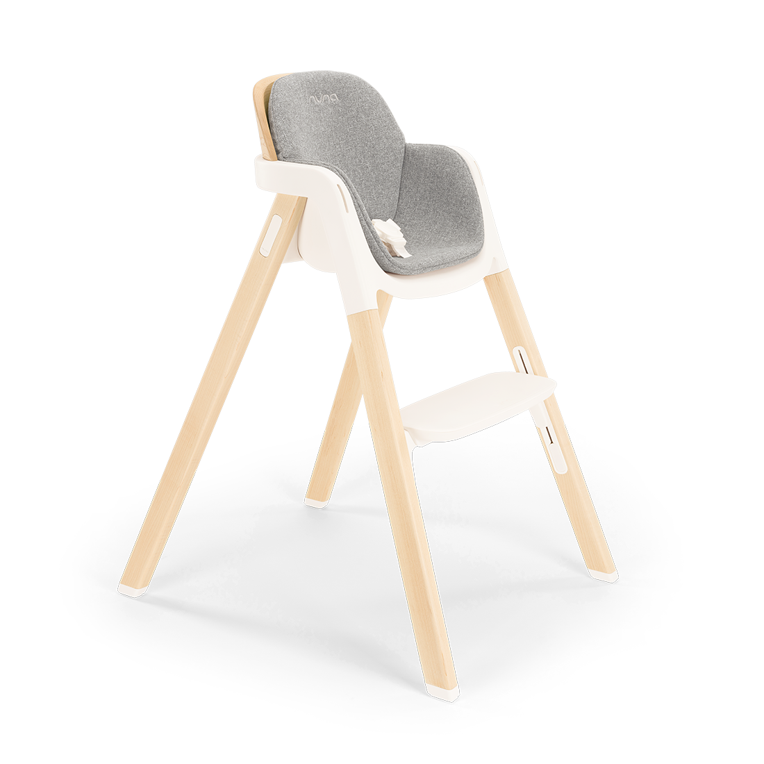 Modern Nuna BRYN highchair with a wooden frame, gray upholstered seat, and white plastic base for versatile use