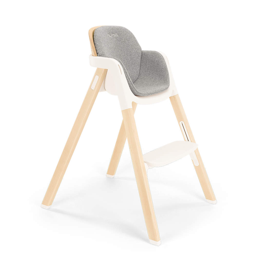 Modern wooden nuna bryn highchair with gray upholstered seat and white plastic frame for comfortable feeding