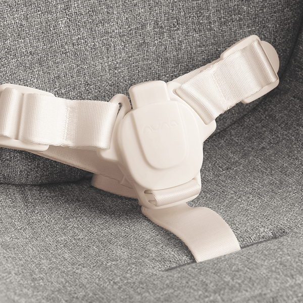 Off-white plastic and fabric safety harness with central buckle for nuna bryn highchair and newborn rocker bundle heritage