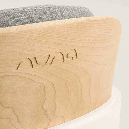 Light-colored wooden frame with subtle grain and auna engraving on the back of nuna bryn highchair heritage model