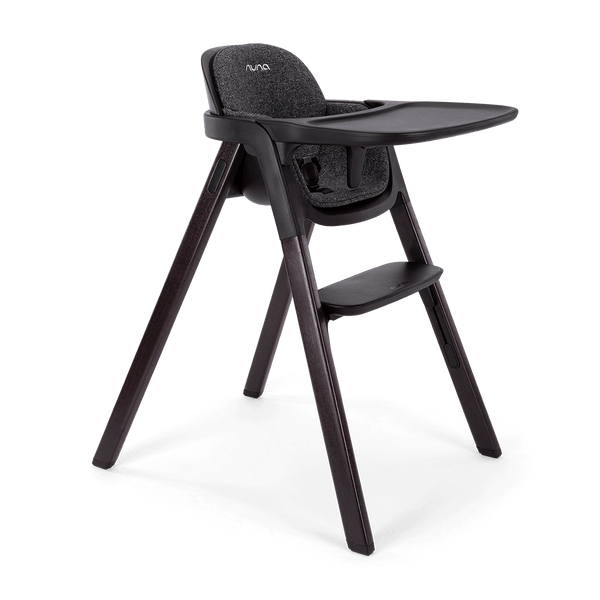 Black Nuna BRYN highchair Metro with textured fabric seat and sleek dark wooden legs for stylish dining seating