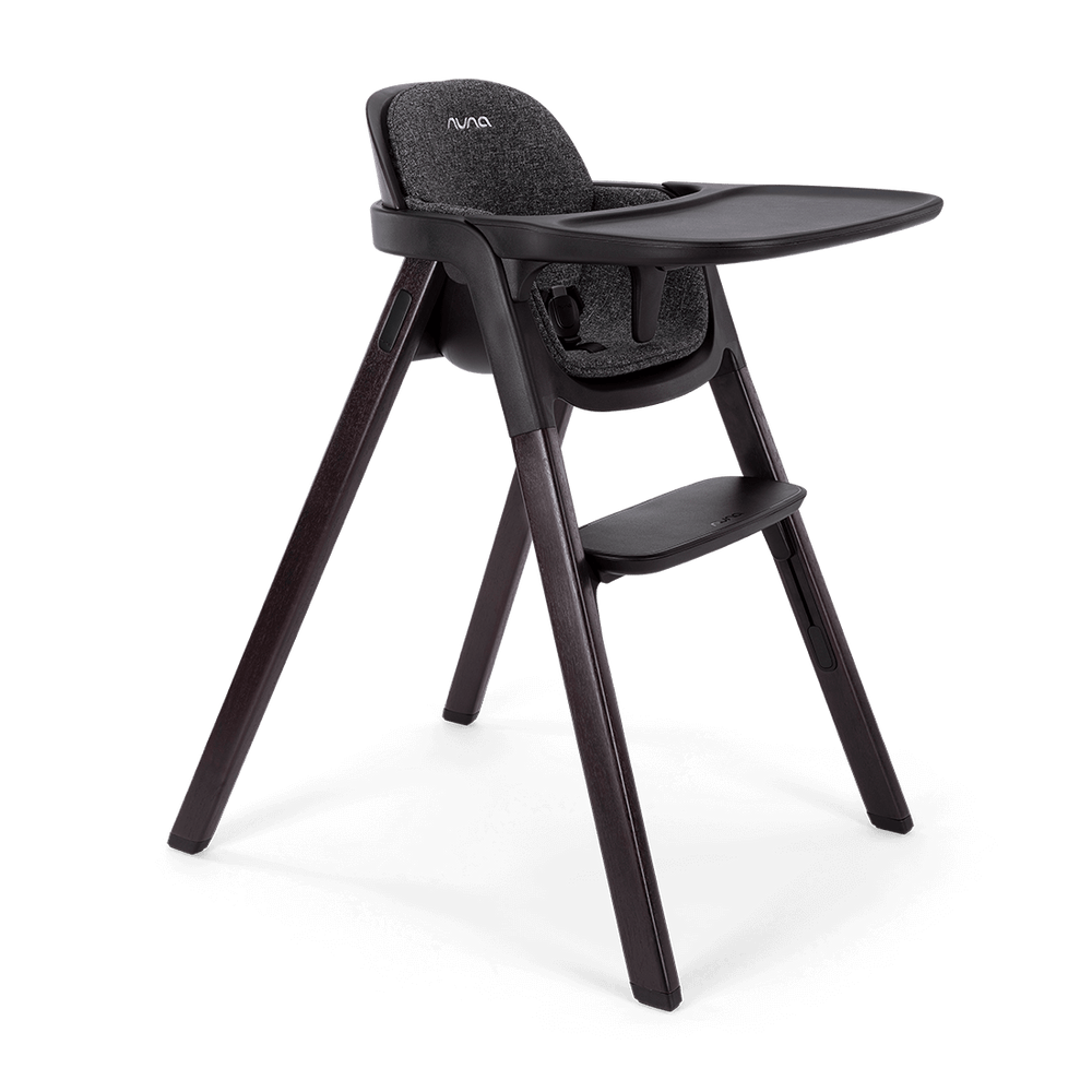 Black Nuna BRYN highchair Metro with textured fabric seat and sleek dark wooden legs for stylish dining seating