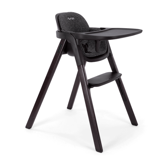 Black Nuna BRYN highchair Metro with textured fabric seat and sleek dark wooden legs for stylish dining seating