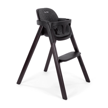 Black Nuna BRYN highchair with textured fabric seat and sleek wooden legs for stylish dining comfort