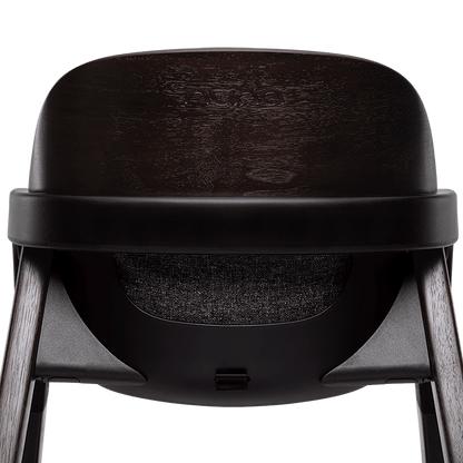 Nuna BRYN highchair metro in black avent with a textured seat and wooden legs for baby feeding