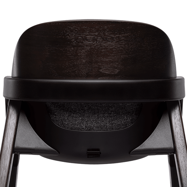 Nuna BRYN highchair metro in black avent with a textured seat and wooden legs for baby feeding
