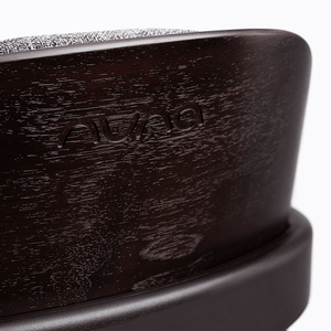 Dark wood-finish nuna bryn highchair metro with textured gray fabric top baby car seat base shown from back side