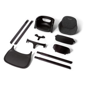 Black plastic and fabric components of a nuna bryn highchair metro baby car seat assembly showing the back side