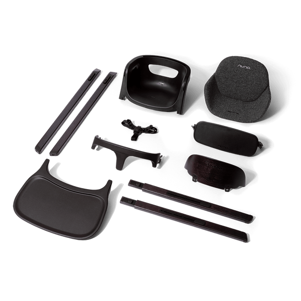 Black plastic and fabric components of a nuna bryn highchair metro baby car seat assembly showing the back side