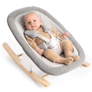 Nuna bryn newborn rocker in heritage gray textured fabric with light wood rockers and white safety harness