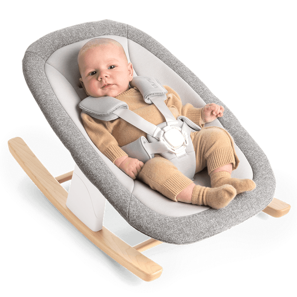Nuna bryn newborn rocker in heritage gray textured fabric with light wood rockers and white safety harness