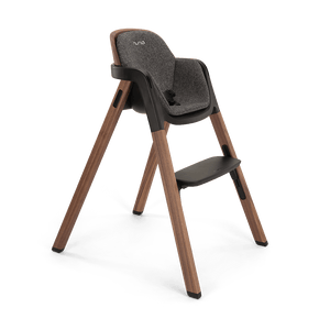 Modern wooden nuna bryn highchair with gray textured fabric seat black accents and nuna logo in sanderson finish